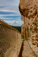 Obraz premium Spiral staircase and fence railing on the Sandia Man Cave Trail in the Sandia Mountains outside of Placitas, New Mexico