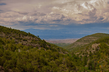 View from the Sandia Man Cave looking towards Placitas, outside of Albuquerque, New Mexico showing the green forest in the Sandia Mountains