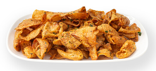 Crispy chicken skin on a white plate.