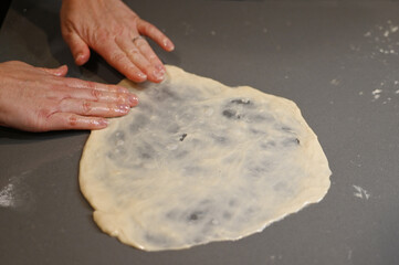 Jewish woman preparing Jachnun or Jahnun, a Yemenite Jewish pastry, originating from the Adeni Jews, and traditionally served on Shabbat morning.