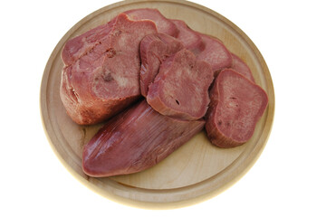 Beef tongue Boiled in pieces on a  wooden board Isolated on a white background.Offal.Cold snacks.