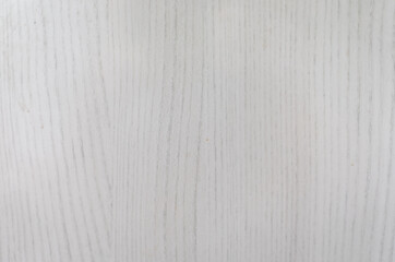 White woodgrain background with grains in a vertical line