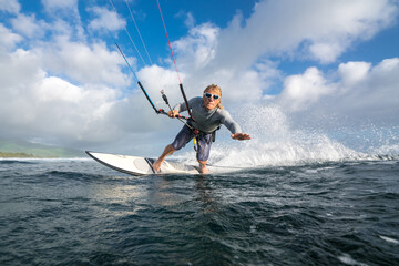 Kitesurfer rides on the waves of the Indian Ocean on the island of Mauritius