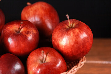 Fototapeta na wymiar Various fresh apples in basket on left side close-up