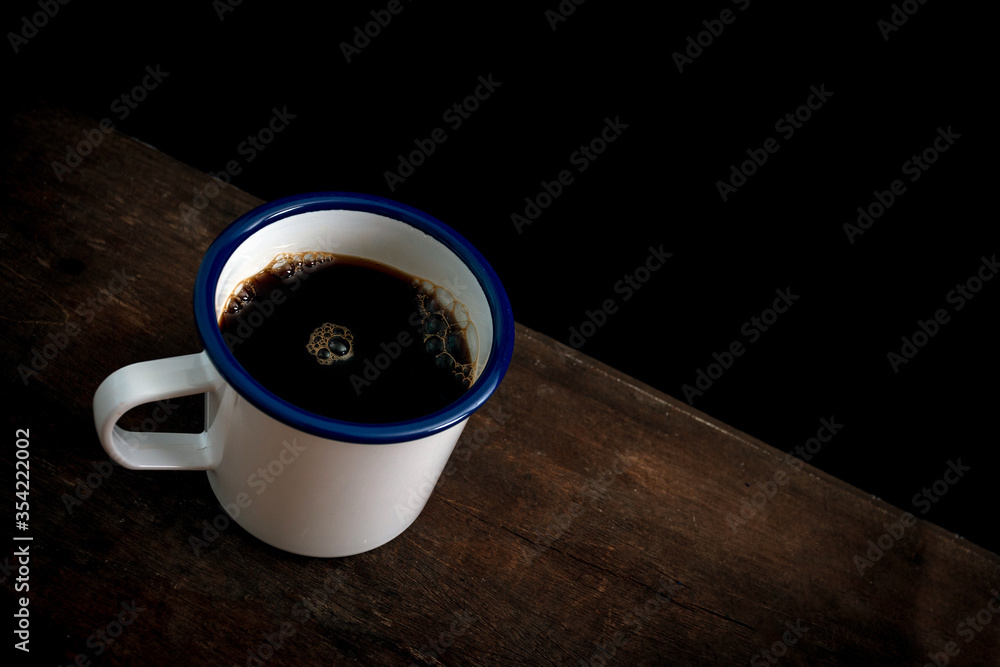 Wall mural cup of coffee on old wooden table