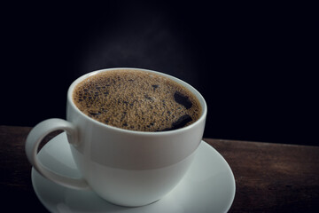 Cup of coffee on old wooden table