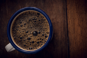Cup of coffee on wooden background. Copy space. Top view. Flat lay