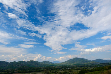Obraz premium The white clouds have a strange shape and moutain.The sky and the open space have mountains below.Clouds floating above the mountains