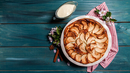 apple tart with caramel, a piece of cake, top view on a wooden board. banner menu recipe place for text. top view
