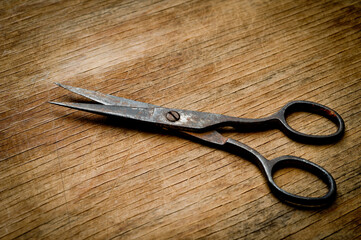 Old iron scissors of the last century covered with rust, removed from the chest in the workshop of grandfather. Background for craftsmanship and manual labor.