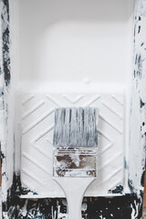 DIY and home improvement, close-up of paint tray with white glossy paint and paint brush
