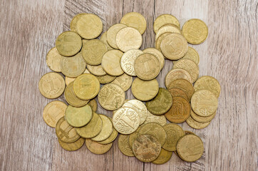 Coins on a wooden background. View from above.