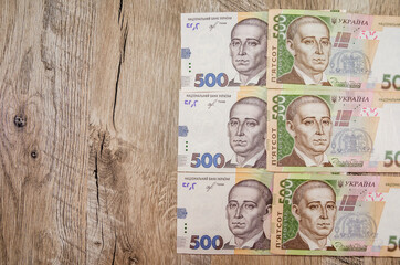 500 hryvnia banknotes on a wooden background. View from above. Copy space. Place for text.