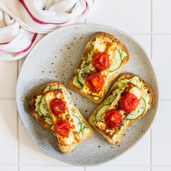 Avocado, Fried Cheese, Cucumber and Tomato Toasts