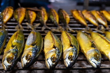 Asian food. Grill fish counter at a night street food market.