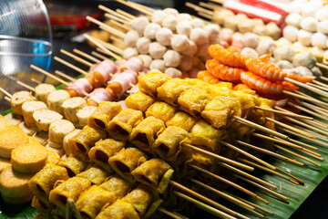 Asian food. Different mini barbecue counter at night street food market.