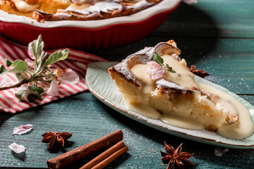 Piece of an apple pie with vanilla sauce on a plate. baking concept