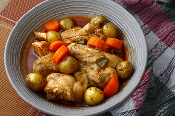 Freshly cooked Filipino food Chicken Afritada or chicken cooked in tomato sauce with potatoes and...