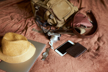 Concept travel prop with a hat and bag and laptop            
