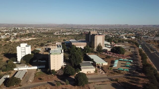 4K aerial drone summer sunny day video of Windhoek Katutura suburb large state hospital near B1 main highway in Namibia's capital in central highland Khomas Hochland of Namibia, southern Africa