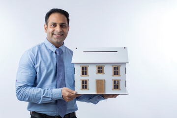 Real estate agent holding a house model