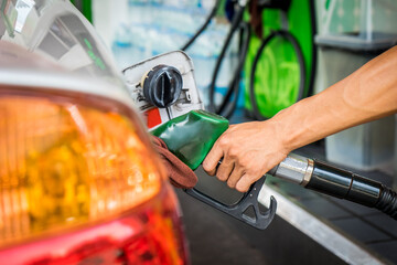 Car refueling fuel on petrol station. Man pumping gasoline oil. Service is filling gas or biodiesel...