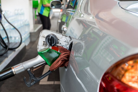 Car refueling fuel on petrol station. Man pumping gasoline oil. Service is filling gas or biodiesel into the tank. Automotive industry or transportation concept