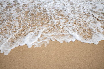 Seascape. Foam waves at sandy beach. Waterscape for background. Soft focus. Motion waves. Copy space. Bingin beach, Bali, Indonesia