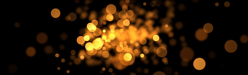 Abstract glitter gold and yellow bokeh glow in the dark on black background. Christmas banner panoramic with golden bokeh.