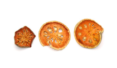 Dried sliced Bael fruit isolated on white background. Bael fruit has anti-inflammatory property, helps to heal digestive disorders, used as a remedy for asthma, and common cold. Herbal tea ingredients