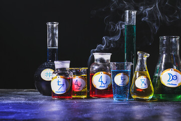 Potions with alchemical symbols on table