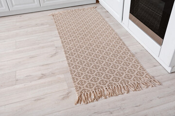Stylish carpet on floor in modern kitchen