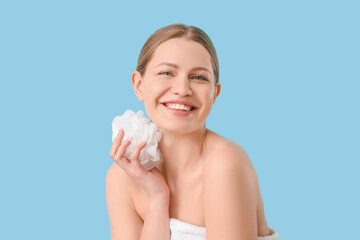 Beautiful young woman taking shower on color background