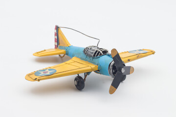 Vintage old yellow blue fighter plane toy Isolated on a white background