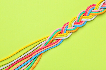 Braided ropes on color background. Unity concept
