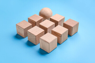 Wooden cubes and sphere on color background. Unity concept
