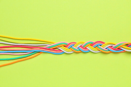 Braided ropes on color background. Unity concept
