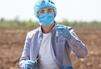 Scientist studying samples of soil in field