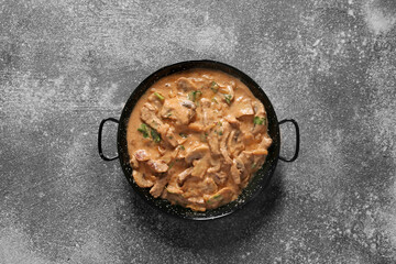 Tasty beef stroganoff on grey background