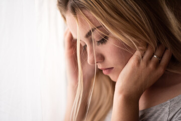 Fototapeta premium Young de-stressed woman looking downwards