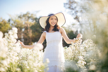 outdoor portrait of a beautiful asia woman. attractive cute girl in a field with flowers