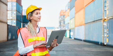 Foreman woman worker working checking at Container cargo harbor holding laptop computer to loading...