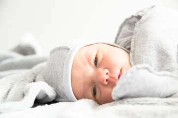 Beautiful newborn sweetly sleeps in the crib and has beautiful dreams
