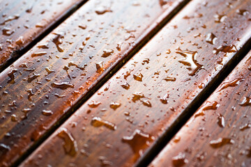 Water drops on a wooden floor surface.Drop of water on wood with raindrop after a rain with copy space.Water resistant painting and Protect hard wood with lacquer.Decor and background Concept.