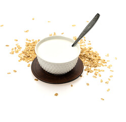 oatmeal with milk in a ceramic bowl on a plate. White background