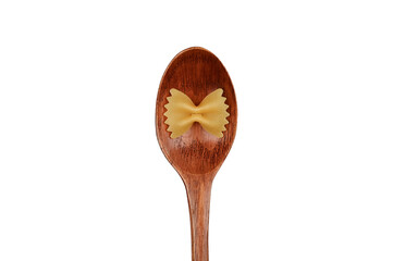 Wooden spoon and pasta in the form of a bow on an isolated background