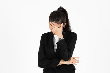 Tired overworked young Asain business woman in suit with hands on face suffering from severe depression over white isolated background. Failure and layoff concept.