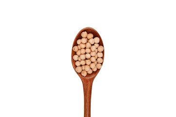 Uncooked chickpeas on wooden spoon. Top view