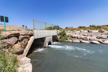 A bridge below which water flows in nahal kibutsim in the Springs Valley israel