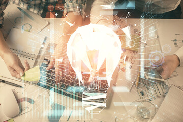 Double exposure of man and woman working together and bulb drawing. Computer background. Top View. Idea concept.